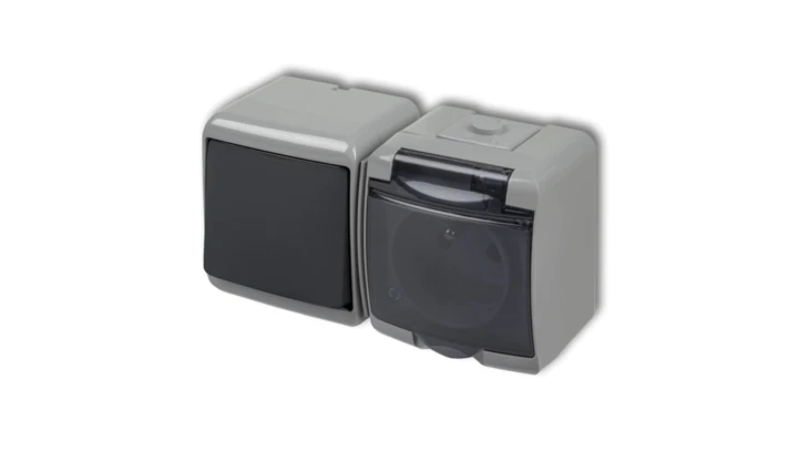 JUNIOR Łącznik jednobiegunowy z gniazdem hermetycznym (klapka dymna) popielaty / grafitowy 30WGHH-1d